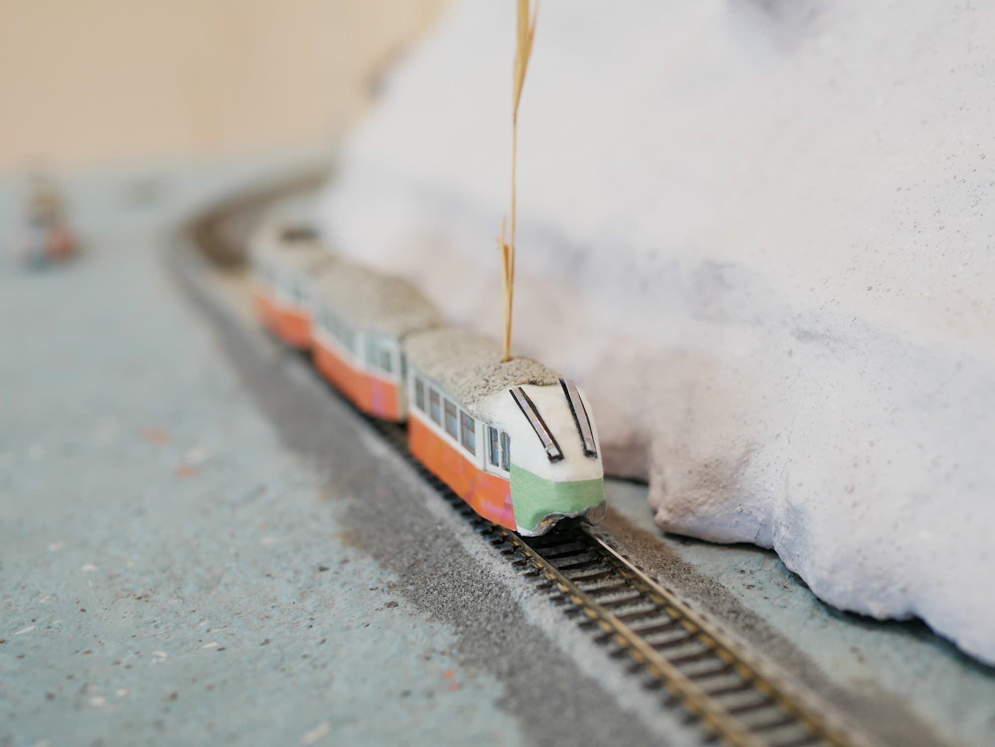 Chris Schultz, photograph: z-scale model train crossing a miniature landscape